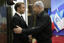 Israeli Prime Minister Benjamin Netanyahu, right, welcomes French President Emmanuel Macron before their talks in Jerusalem on Tuesdat
