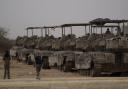 Israeli armoured vehicles are seen parked on an area next to the Israeli-Gaza border, as seen from southern Israel, Thursday, April 25, 2024. (AP Photo/Leo Correa)