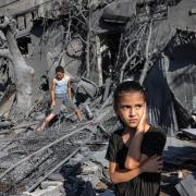 A girl looks on as she stands by the rubble outside a building that was hit by Israeli bombardment in Rafah in the southern Gaza Strip on October 31