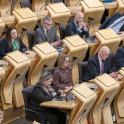 Kate Forbes and John Swinney sitting in the Parliament on Wednesday