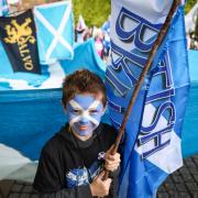 A young Scottish independence supporter at an All Under One Banner march in Glasgow