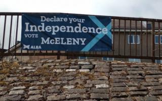 The banner promoting the campaign of Chris McEleny has been placed on railings in Inverclyde