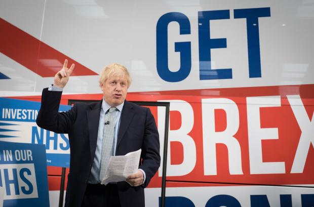 The National: Boris Johnson in front of a Get Brexit Done sign