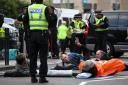 Extinction Rebellion protesters lie down in the road as part of their disruptive protest tactics