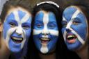 Pro-Independence supporters pose with their faces painted with St Andrew's Cross during a rally in George Square in Glasgow