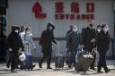 People returning to Beijing will now have to isolate themselves at home for 14 days