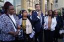 Sheku's mother Aminata Bayoh (2nd left) with Sheku's sisters as lawyer Aamer Anwar (centre) speaks to supporters outside Capital House in Edinburgh. Photo: PA