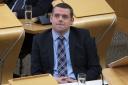 Douglas Ross's party has been accused of 'hiding' over 'asylum ban' plans