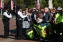 A member of the public argues with police after trying to leave a crowded area at Buckingham Palace