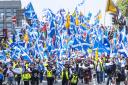 Scottish independence supporters walk through Glasgow during an All Under One Banner march