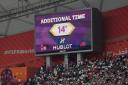 The big screen displays 14 minutes of added time in the first half of England's game against Iran