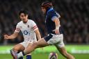 LONDON, ENGLAND - FEBRUARY 04: Marcus Smith of England kicks past George Turner of Scotland during the Six Nations Rugby match between England and Scotland at Twickenham Stadium on February 04, 2023 in London, England. (Photo by Dan Mullan - RFU/The RFU