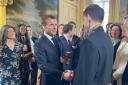 Archippus Sturrock shakes hands with French President Emmanuel Macron