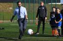Humza Yousaf plays football during a visit to a school holiday club at Ayr Academy in Ayr, to announce additional funding to support families.