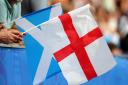 A fan waves a Scotland flag and and England flag during the FIFA Women's World Cup