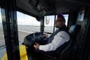 Stuart Doidge sits in the drivers seat with no hands on the wheel on one of the new buses as it crosses Forth Road Bridge