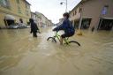 Exceptional rains in a drought-struck region of northern Italy swelled rivers over their banks, killing at least eight people