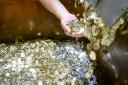 Pound coins roll off the production line at the Royal Mint