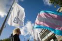An activist holds a transgender pride flag outside the first annual conference of the LGB Alliance