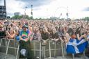 Festival goers watch George Ezra performing on the main stage at the TRNSMT Festival at Glasgow Green in Glasgow