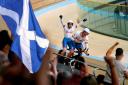 Scotland's Neil Fachie celebrates winning gold with teammate Matt Rotherham as pilot