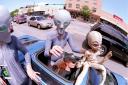 Groups dressed as aliens ride through downtown Roswell, New Mexico July 1, 2000 as they participate in the annual UFO Encounter