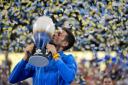 Novak Djokovic kisses the Rookwood Cup as he poses for photos after defeating Carlos Alcaraz during the final of the Western & Southern Open (Aaron Doster, AP)