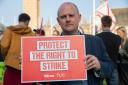 General Secretary of the Trade Union Congress Paul Nowak holds up sign calling to protect the right to strike