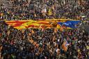 Catalan independence supporters fly the Estelada in Plaza de Espana square in Barcelona