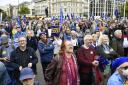 Demonstrators take part in a National Rejoin the EU March in Parliament Square, London