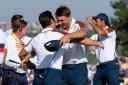 Europe’s Viktor Hovland, left and Europe’s Ludvig Aberg hug on the 11th green after defeating the United States pair of Scottie Scheffler and Brooks Koepka (Gregorio Borgia/AP)