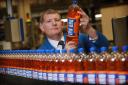 AG Barr chief executive Roger White pictured holding a bottle of Irn Bru