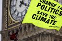 File photograph provided by Greenpeace of climate protesters outside the Houses of Parliament