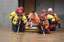 Members of the emergency services help local residents to safety in Brechin, Scotland