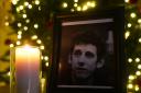 A candle burns next to a photograph of The Pogues frontman Shane MacGowan at the Mansion House, in Dublin, after a book of condolence was open by the Lord Mayor of Dublin