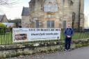 Inchgreen campaigner Alasdair Higgins with the banner at Old West Kirk shortly after its installation.