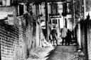 Police and nurses in the 'lane of death,' in Glasgow, during the Bible John murders