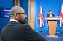 Home Secretary James Cleverly watches Rishi Sunak give a press conference in Downing Street