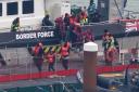 A group of people thought to be asylum seekers disembark at Dover