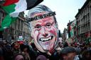 Pro-Palestinian activists and supporters carry a giant mask of Labour Party leader, Keir Starmer