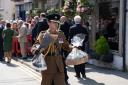 The King's equerry carries baskets of treats and flowers given to the King by well-wishers
