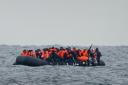 A group of migrants crossing the Channel in a small boat (PA)