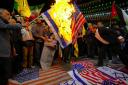Protesters in Tehran burn American and Israeli flags