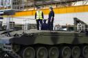 Defence Secretary Grant Shapps stands atop a Challenger 3 tank prototype being built by BAE Systems