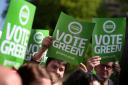 Green party supporters hold placards as Green party co-convener Patrick Harvie(not pictured) launches the Scottish Greens Glasgow North General Election campaign