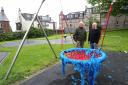 Councillors Michael McCormick and Colin Jackson look at the vandalised swing in Bawhirley playpark