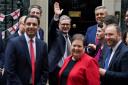 Keir Starmer waves to members of the media after taking a photograph with the new intake of Scottish Labour MPs