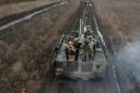 Russian Army soldiers ride their armoured toward positions at an undisclosed location in Ukraine