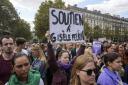 People take part in a gathering in support of 71-year-old Gisele Pelicot who was allegedly drugged by her ex-husband and raped by dozens of men while unconscious, Saturday, Sept. 14, 2024 in Paris. Placard reads, "support for Gisle Pelicot."