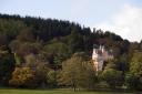 Craigievar Castle in Aberdeenshire, Scotland, surrounded by trees in autumn colours